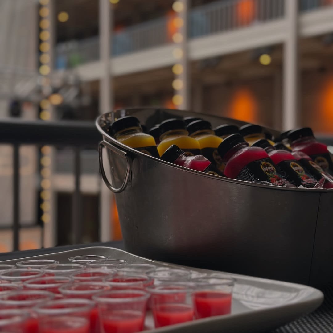 Cold-pressed juice bottles and tasting samples at the market